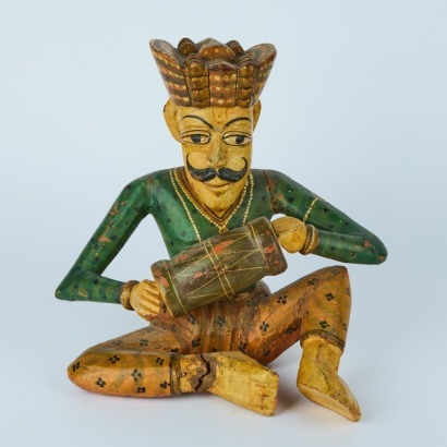 A Folk Art Carved Figure with a Guitar