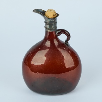 An Amber Glass Bottle with a Pewter Pourer