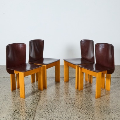 A Set of Four Vintage Italian Chocolate Leather and Beech Dining Chairs
