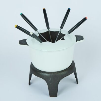 A Cast Iron Fondue Pot Stand and Forks
