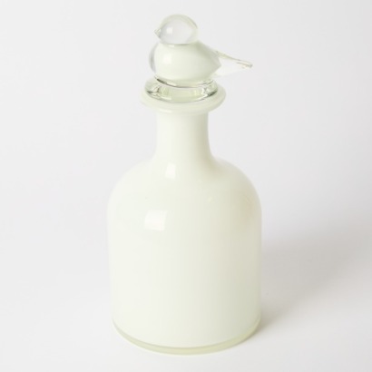A Decorative White Glass Decanter With Bird Stopper