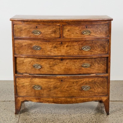 A Bow Front Walnut Chest of Drawers