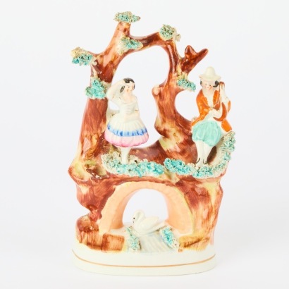 A Staffordshire Porcelain Figurine of a Couple in a Tree
