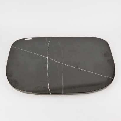 A Large Black Granite Stone Serving Board On Swivel Base