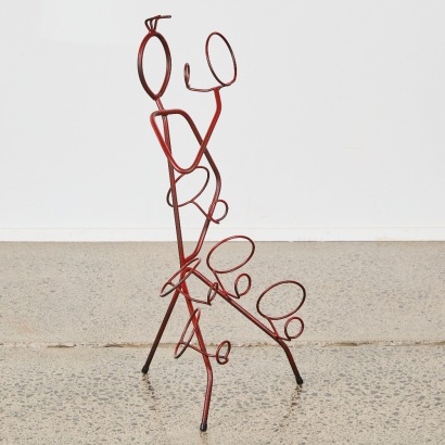 A Figural Wrought Iron Wine Bottle Holder For Six Bottles