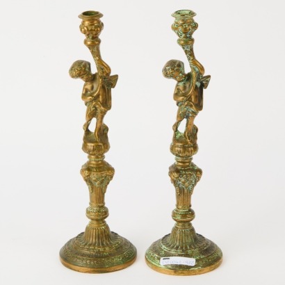 A Pair of Brass Cherub Candleholders