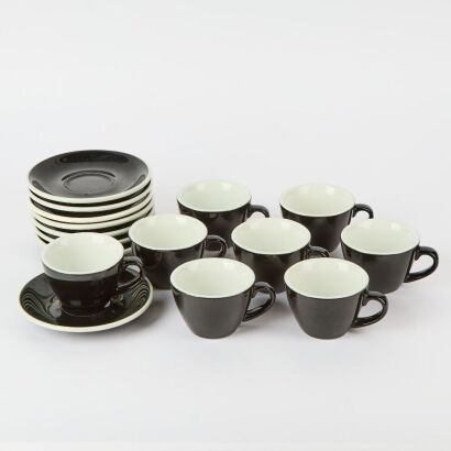 A large set of eight ACME Cups and Saucers in Black