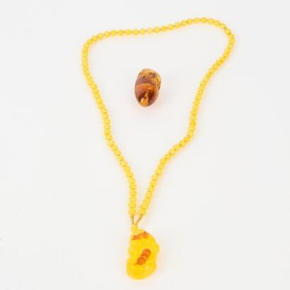 Two Chinese Yellow Amber Pendants