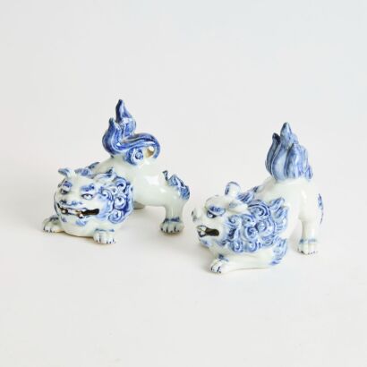 A Pair of Japanese Early 20th Century Blue and White Porcelain Lion Ornaments
