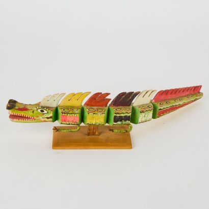 A Hand Painted Folk Art Articulated Wooden Dragon