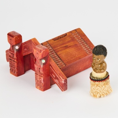 A Folk Art Whare Moneybox and Kewpie Tane