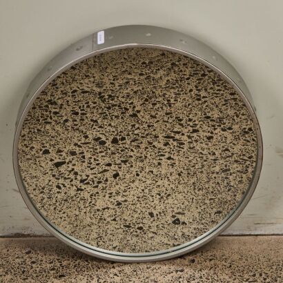 A Round Industrial Wall Hung Mirror