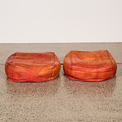 A Pair of Red Leather Footstools