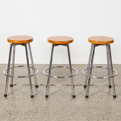 A Trio of Barstools With Wooden Seats