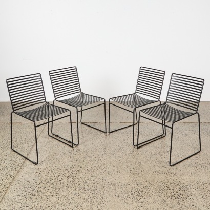 A Set of Four Black Wire Club Chairs