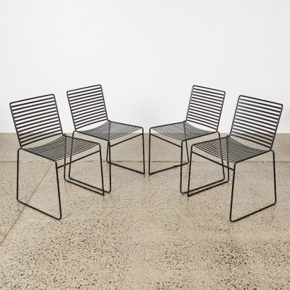 A Set of Four Black Wire Club Chairs