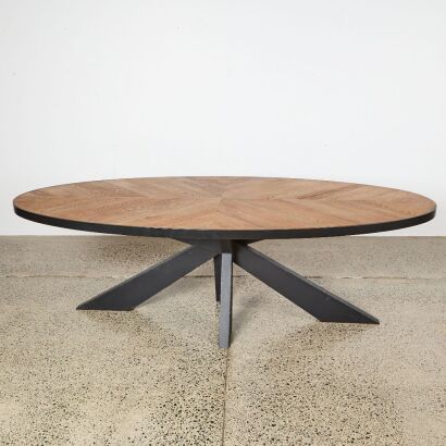 A Large Oval Dining Table Made From Solid Rustic Oak And Metal Base