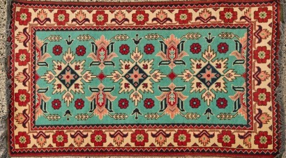 A Turquoise, Cream and Red Turkish Rug