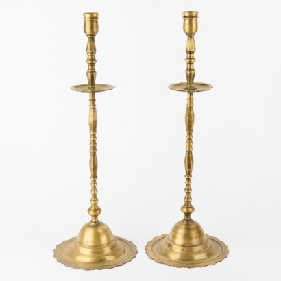 A Pair of Tall Brass Candlesticks