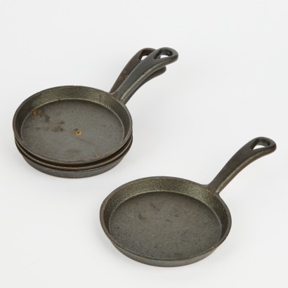 A Set of Four Petite Cast Iron Frying Pans