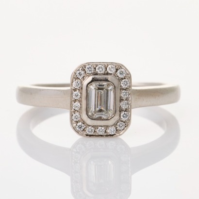 18ct White Gold, .34ct Emerald Cut Diamond / .08ct Round Brilliant Cut Diamond Ring