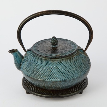 A Metal Japanese Teapot and Stand