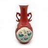 A Chinese Red Ground Famille Rose Vase decorated with panels