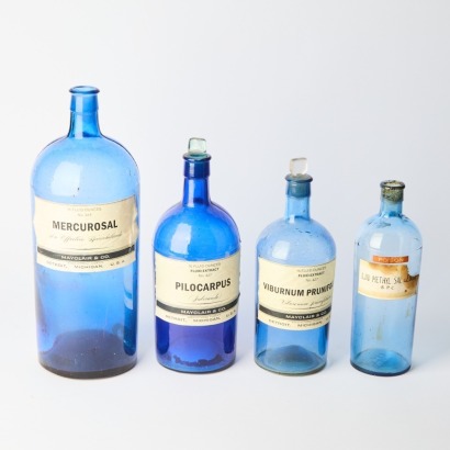A Collection of Four Vintage Apothecary Bottles
