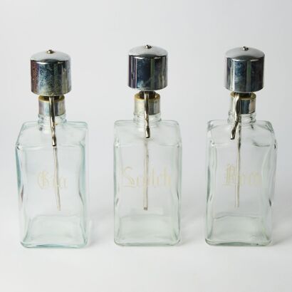 A Trio of Etched Spirit Decanters With Deco Styled Nips