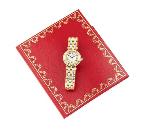 A Lady's gold and stainless steel Panthere Vendome wristwatch, Cartier, circa 1993. Quartz. 24mm. Ref: 1057920. Circular case, cream dial with printed black Roman numerals. Cabochon sapphire crown. Case, dial and two-tone bracelet signed. Papers. 