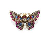 An antique diamond, sapphire, ruby and pearl butterfly brooch, circa 1890. The wings set throughout with rose cut diamonds, cabochon rubies and sapphires and centering on a baroque pearl body, fine engraved detail to the reverse. 14ct yellow gold and silv