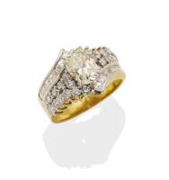 A diamond ring, the crossover style ring claw set with a central oval cut diamond of estimated weight 1.20 carats and round brilliant, baguette and carre cut diamonds of total estimated weight 1.27 carats. 18ct yellow gold. Weight 7.26 grams. Size K. Gemm