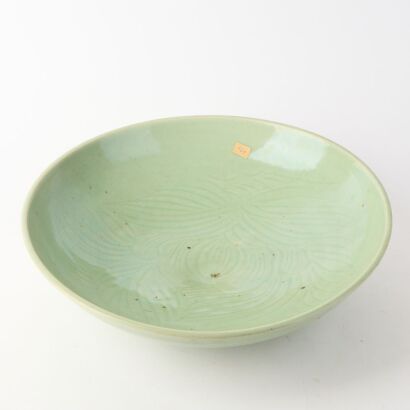 A Chinese Late Ming To Early Qing Celadon-glazed Carved Charger