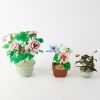 A Group Three Chinese Coloured Glass Floral Potted Arrangements