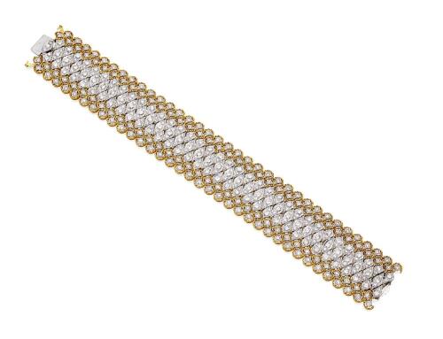 A gold and diamond bracelet, the flexible two tone bracelet set throughout with round brilliant cut diamonds of estimated total weight 10 carats. 18ct yellow and white gold. Weight 47.80 grams. Length 18cm. Width 25mm.