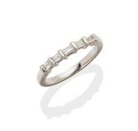 A diamond eternity band, the front section horizontally set with five baguette diamonds of known total weight 0.33 carat. Platinum and palladium. Size L.