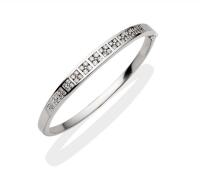 A diamond bangle, the graduated front section of the hinged bangle, channel set with brilliant diamonds of total estimated weight 1.52 carats. 18ct white gold. Weight 29.7 grams. Inside diameter 6cm.