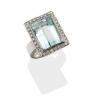 An aquamarine and diamond ring, bezel set with rectangular step cut aquamarine of estimated weight 12.8 carats, in a diamond set frame. Estimated diamond weight 0.40 carat. 18ct white gold. Weight 19.72 grams. Size M. Gemmologists report available.