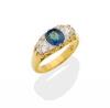 A sapphire and diamond bridge ring, the central round blue sapphire of known weight 1.12 carats set either side with a modern round brilliant cut diamond of estimated total weight 0.67 carat. 18ct yellow gold. Weight 5.5 grams. Size N. Gemmologist's repor