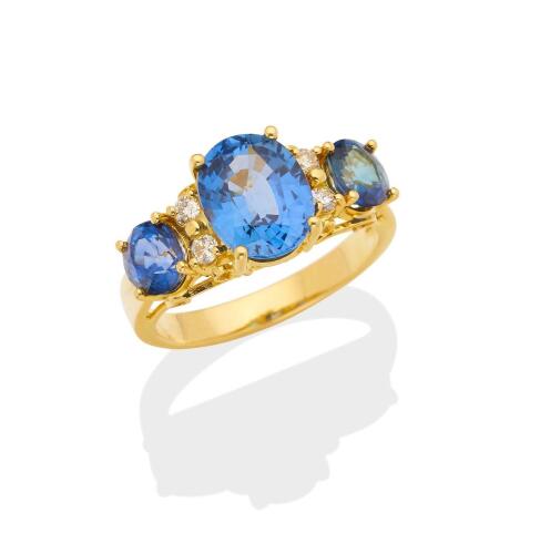 A sapphire and diamond ring, the central oval blue sapphire of estimated weight 4 carats, set either side with a similar oval sapphire, each of estimated weight 1.10 carats and small brilliant cut diamonds. Total estimated sapphire weight 6.10carats. Tota