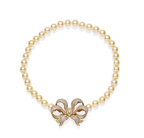 An Akoya pearl necklace, the thirty-six round pearls measuring 9mm and hung with a detachable pave diamond set bow brooch/clasp. 18ct yellow gold. Length 39cm. 