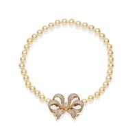 An Akoya pearl necklace, the thirty-six round pearls measuring 9mm and hung with a detachable pave diamond set bow brooch/clasp. 18ct yellow gold. Length 39cm. 