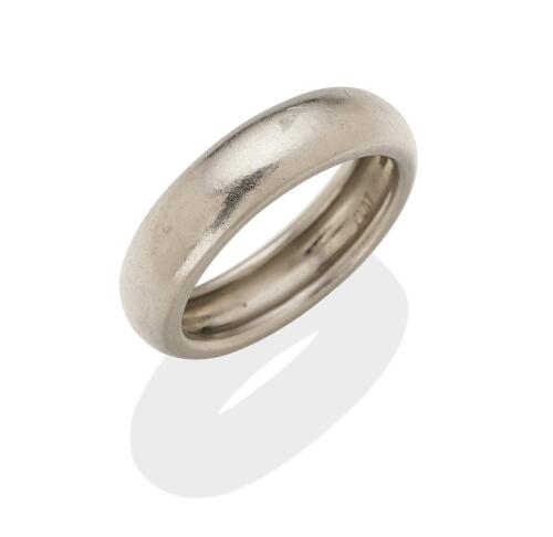 A platinum ring, of plain polished design. Weight 10.70 grams. Width 5.60mm. Size P.