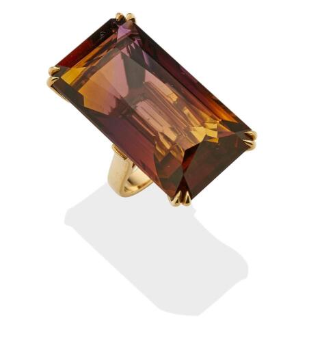 An ametrine cocktail ring, the large rectangular ametrine of known weight 59.6 carats. 9ct yellow gold. Weight 21.1 grams. Size O. Gemmologist's report available.