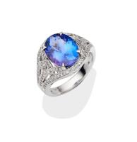 A tanzanite and diamond ring, the oval tanzanite of estimated weight 4.90 carats in a pierced diamond mount. 18ct white gold. Weight 8.37 grams. Size Q.