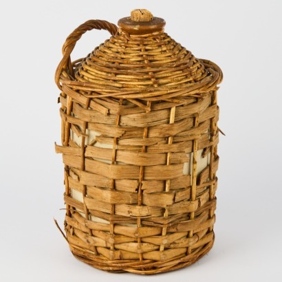 A Vintage Crock With a Woven Wicker Cover
