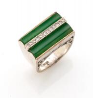 A jade and diamond ring, the two bar set oblong jade stones separated by a single row of bead set diamonds in a pierced setting. White gold. Weight 13.37grams. Size M.