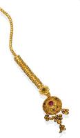 An Indian gold, ruby and enamel Tikka or Bindi. 21ct yellow gold. Weight 7.83 grams. Length 15cm.