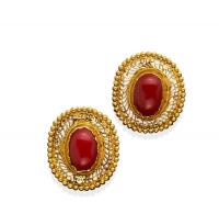 A pair of Indian coral earrings, the oval coral cabochon bezel set within a pierced and beaded surround. 22ct yellow gold. Weight 9.32 grams. Length 25mm. Threaded post attachments.