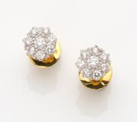 A pair of diamond cluster ear studs, of traditional cluster design, each stud set with eight round brilliant cut diamonds, estimated total weight 0.90 carat. 18ct yellow gold, rhodium plated. Weight 2.52 grams. Threaded post attachments. Gemmologist's rep